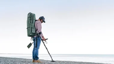 Man Metal Detecting on the Beach