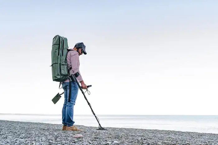 Man Metal Detecting on the Beach